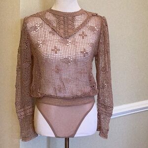 Free People nude crocheted bodysuit size small.  Delicate flowers/detail work